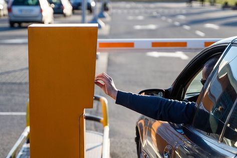 Person in the car inserting into or removing ticket from parking vending machine. Paying, entering parking lot or exiting garage concept. Daytime setting Parking Ticket, Parking Tickets, Parking Garage, Vending Machine, In The Car, Car Park, Parking Lot, Car Parking, Garage