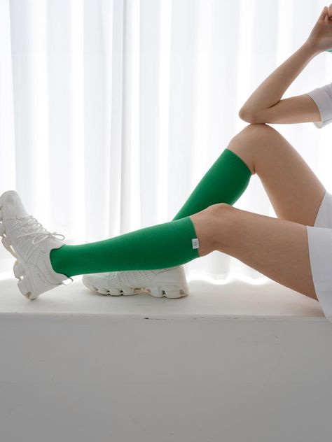 Nitina's Vivid Knee Socks combine everyday style with athletic functionality, featuring clean, vibrant colors and a signature label at the top. The cotton-spandex blend (80/20) offers year-round comfort with optimal thickness, while the ribbed finishing prevents unwanted stretching. These knee-length socks, available in six colors including Green, Orange, and Blue, are designed to seamlessly transition between daily wear and sports activities.Country of Origin: Republic of KoreaColor: Green Knee Length Socks, Knee Socks, Sports Accessories, Sports Activities, Green Orange, Everyday Style, Cotton Spandex, Stretching, Everyday Fashion