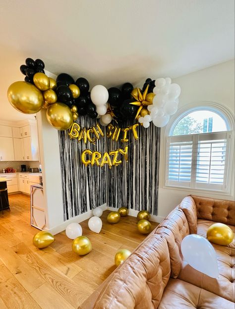 Gold, white and black balloon garland with Bach shit crazy gold letter balloons and a black tinsel curtain, installed in an Airbnb in Austin Texas Black And Gold Bachelorette Party Decor, Black And White Bachelorette Theme, Balloon Arch Bachelorette, Black And Gold Bachelorette Party, Black And White Balloon Arch, White Balloon Arch, Gold Bachelorette Party Decorations, Austin Bachelorette Party, Austin Bachelorette