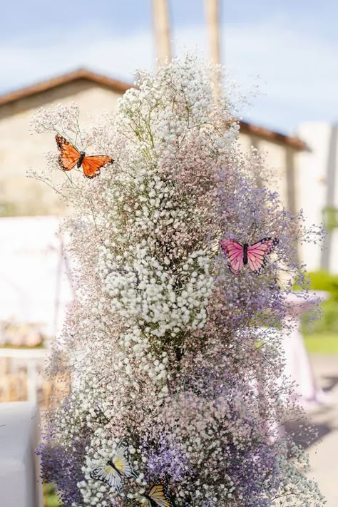 Lavender, pink, cream and white baby's breath arranged in whimsical tower with sweet butterflies for this sweet birthday party. Flower Arrangements With Butterflies, Flower Butterfly Baby Shower Theme, Wildflower Butterfly Baby Shower Ideas, Lavender Tea Party Decor, Butterfly Floral Arrangements, Butterfly Themed Graduation Party, Fairy First Centerpieces, Flower And Butterfly Baby Shower Theme, Blue Butterfly Centerpieces