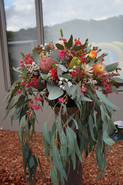 Large arrangement of banksias, gum leaves, tetragona, tea tree, flowering gum and orange roses in a rustic chimney flu. By RANE flowers Native American Floral Arrangements, Gum Leaves Table Decorations, Large Native Flower Arrangements, Australian Native Wedding Table Flower Arrangements, Native Floral Arrangements, Australian Flower Bouquet, Australian Native Wedding Flowers, Native Flower Arrangements, Rustic Chimney