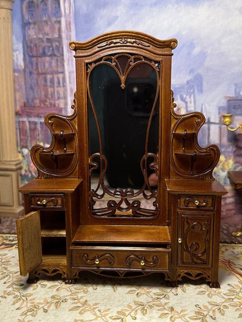 I am offering a beautiful new, 1:12,  walnut Art Nouveau dressing table. The dressing table has drawers that open and close and a large mirror. The original armoireg was designed and made in France where Art Nouveau originated in the late 1800s. The purpose of Art Nouveau was to bring artists, designers, decorative artists, illustrators and architects together to attempt to unify the arts and eliminate difference between fine and decorative arts. They wanted to create a new style going into the Art Nouveau Mirror, Vintage Miniature Furniture, Art Nouveau Vanity, Dollhouse Mirror, Art Nouveau Miniatures, Art Nouveau Desk, Define Art, Art Nouveau Furniture, Curved Wood