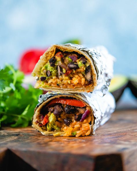 The ultimate vegan burrito! A flavor-packed plant based lunch or dinner idea, it's stuffed with Mexican rice, seasoned black beans and peppers, and avocado. #vegan #veganburrito #burritorecipe #burritos #mexican #plantbased #healthyrecipe Seasoned Black Beans, Vegan Burritos, Best Vegan Chili, Vegan Fajitas, Vegan Enchiladas, A Couple Cooks, Authentic Mexican Food, Traditional Mexican Dishes, Vegan Burrito