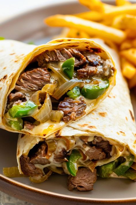 This Philly cheesesteak wrap turns the classic sandwich into a portable lunch! It's packed with tender beef, melty provolone, peppers, and onions. Cheesesteak Wrap, Cheesesteak Meatloaf, Homemade Buttermilk Cornbread, Shrimp Gumbo Recipe, Chicken Satay Recipe, Steak Wraps, Philly Steak, Beef Wraps, Classic Sandwich