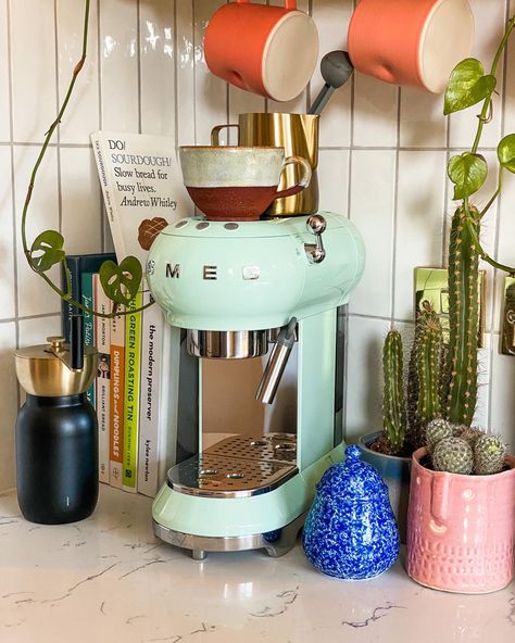 Mint green retro style Smeg coffee machine styled in electric kitchen with ceramic mugs, cook books and cacti plants. Mint Green Kitchen Decor, Smeg Mint Green, Smeg Appliances In Kitchen, Smeg Green, Coffee Machine Station, Smeg Aesthetic, Kitchen With Plants, Smeg Espresso Machine, Green Smeg