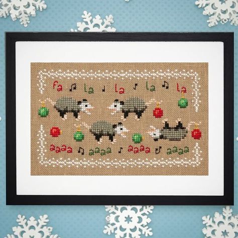 Lola Crow on Instagram: ""Fa La Aaaa" What better way to celebrate the holidays than with a passel of opossums! And, yes, one of them is playing opossum. New pattern now available. #lolacrowcrossstitch #lolacrow #crossstitch #holidayopossum #christmasopossum #opossumcrossstitch #christmaspossum #holidaystitching #fiberart #crossstitchersofinstagram #christmascrafts #opossum #nerdycrossstitch #crossstitchpattern" Possum Embroidery, Cross Stitch Axolotl, Opossum Cross Stitch, Cross Stitch Opossum, Wombat Cross Stitch Pattern, Possum Cross Stitch, Possum Cross Stitch Patterns, Tiny Cross Stitch, Mini Cross Stitch