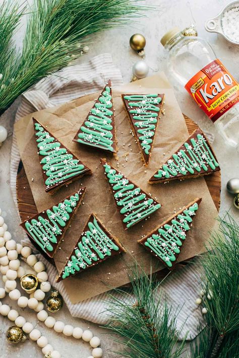 These no bake bars are the perfect treat for the Holidays. They're easy to make, and filled with crispy rice cereal, oats, pretzels, and a caramel peanut butter filling. They're so quick and easy to make, and are perfect for decorating with the kids! #nobake #peanutbutter #christmas #christmasrecipes #butternutbakery | butternutbakeryblog.com Karo Syrup No Bake Bars, Banana Cream Pie Bars, Bake Banana, Tree Bar, Karo Syrup, Peanut Butter Jar, Peanut Butter No Bake, Tree Cookies, Pie Bars