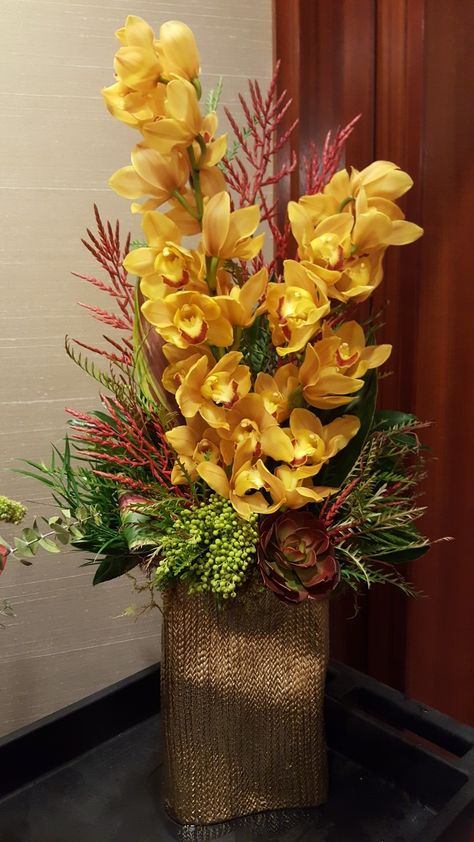 Cymbidium orchid arrangement Flower Arrangements With Orchids, Cymbidium Orchids Arrangement, Greenery Floral Arrangement, Rustic Flower Arrangements, Tall Flower Arrangements, Casket Flowers, Orchid Flower Arrangements, Tropical Floral Arrangements, Cymbidium Orchid