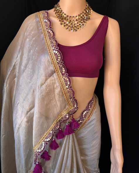 Silver mettalic tissue saree with contrast magenta golden lace all over sarees. Comes with beautiful big magenta thread tassels on pallu. Blouse: running blouse 80cm. To find this product in website: Www.thejacouture > Tissue sarees> silver mettalic tissue saree. Jewellery collaboration: @anvi__jewellery #mettalictissuesaree #silversaree #fancysaree #tissuesaree #trendingsaree #tissuelacesaree Silver Saree With Contrast Blouse, Golden Saree With Contrast Blouse, Net Saree Designs, Magenta Saree, Saree Combination, Saree With Contrast Blouse, Tissue Sarees, Golden Blouse, Thread Tassels