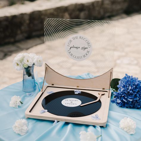 🎶Record your memories! Impress your guests with our unique Vinyl Record Guest Book! Created to save the heartfelt wishes of your loved ones not only a functional accessory but also a stylish piece of vintage decor for music lovers and retro fans.  🎶With every little detail we design, we want your guests to feel the atmosphere of a timeless era so we offer you a a great variety of additional options. You can choose simply one personalized vinyl record plate or get a set of them, a table stand, and a record player to enhance the retro spirit of your vintage party. Additionally, you can complete your wedding decor with the same-style notebook to make sure all your guests leave a few warm words. 🎶Please, note that the vinyl record plate and the player are decorative imitations and are not d Record Guest Book Sign, Record Guest Book, Golden Bday, Custom Vinyl Record, Lover Wedding, Decorative Stand, Wedding Guest Books, Vinyl Record Player, Retro Fan