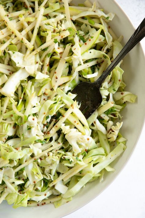 This Apple Coleslaw Recipe is made with sweet apples, shredded cabbage, green onions, and a light dijon vinaigrette. Healthy, crunchy, and super easy to make, enjoy this apple slaw with all your favorite lunch and dinner recipes. Green Apple Slaw Recipe, Asian Apple Slaw, Green Apple Coleslaw, Green Apple Coleslaw Recipe, Apple Slaw For Pulled Pork, Coleslaw Recipe Apple, Cabbage Apple Salad, Coleslaw With Apples, Cabbage Apple Slaw