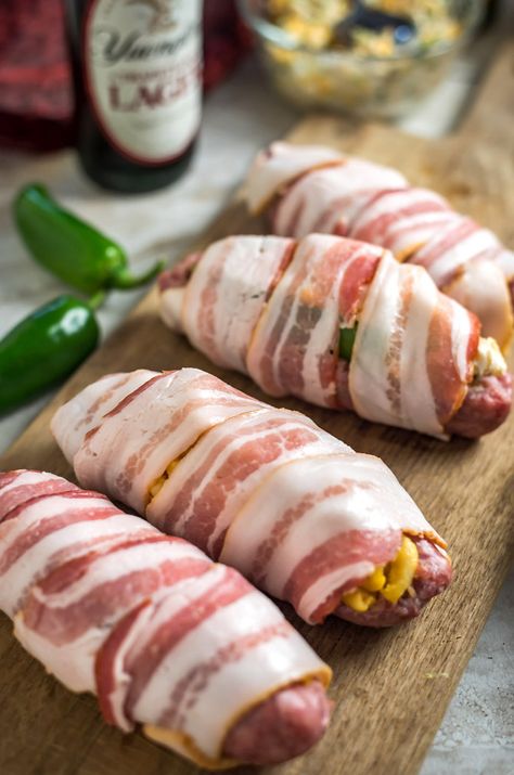 Bacon-Wrapped Stuffed Beer Bratwurst. Don’t just put the toppings on your beer brats, put them *in* them, too! Stuff ‘em, wrap ‘em in bacon, and grill ‘em until crisp. Click through for 4 filling ideas including mac & cheese, pimento cheese, sauerkraut, and jalapeño popper. | hostthetoast.com Beer Bratwurst Recipes, Stuffed Brats, Brat Sausage, Baseball Food, Bacon Wrapped Cheese, Beer Bratwurst, Bratwurst Recipes, Beer Brats, Pork Entrees