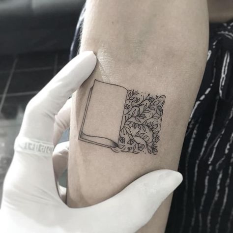 Book Nature Tattoo, Subtle Book Tattoos, Minimalist Book Tattoo, Book Tattoo Ideas, Lotusblume Tattoo, Minimalist Tattoo Meaning, Paris Tattoo, Bookish Tattoos, Typography Tattoo