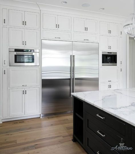 Floor to ceiling cabinets frame a large French door refrigerator boasting abundance of cabinet storage accented with nickel hardware. Glass Fronted Kitchen Cabinets, White Wood Paneling, White Shaker Kitchen Cabinets, Floor To Ceiling Cabinets, Upper Kitchen Cabinets, Large Refrigerator, White Shaker Kitchen, White Shaker Cabinets, Shaker Kitchen Cabinets