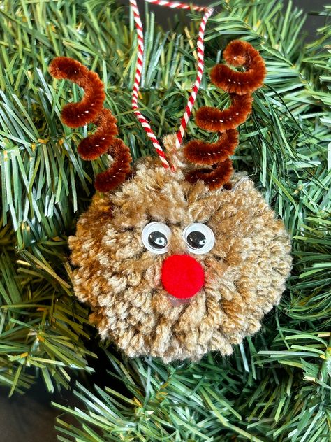 Add some fun to your Christmas tree with this handmade ornament made with yarn pom poms, red nose, and googly eyes. Each ornament is handmade and may vary slightly. Pompom Christmas Tree Ornaments, Easy Kids Christmas Decorations, Tree Ornament Crafts For Kids, Reindeer Christmas Crafts, Pom Pom Reindeer, Kids Ornaments Craft, Pompom Crafts Ideas, Easy Yarn Ornaments, Raindeer Craft