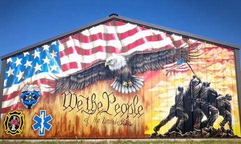 Muralist Sandra Pemberton, of Neosho MO, painted the 12’x20’ mural was painted in Sept 2021. Depicted in the mural, an American flag sweeps across the eaves above, arcing overtop a bald eagle whose wings are outstretched. At bottom right, the flag-raising soldiers from the Battle of Iwo Jima strike a bold silhouette before a glowing sunset. Beneath eneath the eagle, “We The People” is written. . At bottom left, a tribute to first responders and law enforcement. precise location unknown Patriotic Mural, Iwo Jima Flag Raising, Iwo Jima Flag, Painted Window Art, Battle Of Iwo Jima, Farm Building, Eagle Project, Patriotic Wall, American Flag Eagle