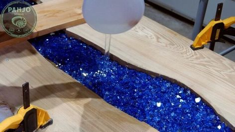 In this HT post, I show you how to make a glow in the dark epoxy bar top using reclaimed wood with embedded blue fire glass. Reclaimed Sinker Cypress WoodFirst, I used reclaimed sinker cypress wood for this epoxy bar top.  Obviously, I fell in love with the beauty of this reclaimed wood, which is pulled from the river bottom all along the gulf coast.I contacted a local Sinker Cypress Logger to purchase a slab for this live edge epoxy bar top using reclaimed wood.Ultimately,… Epoxy River Bar Top, Epoxy Bar Top Ideas, Diy Bar Top, Epoxy Bar Top, Epoxy Counters, Glow In The Dark Epoxy, Trippy House, Sinker Cypress, Diy Garden Bar