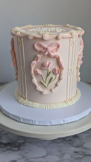 Kaly | Buttercream Flowers | Vintage Lambeth Cakes on Instagram: "Full spin of the Lana Del Rey cake.  Cake Deets: Funfetti Cake Vanilla Buttercream  . . . #bostoncakedesigner #bostoncakeartist #bostoncakes #bostoncake #coquettecake #coquetteaesthetic #coquettecore #coquette #vintagecake #vintageaesthetic #aestheticcake #aestheticcakes #floralcakedesign #floralcakes #floralcake #flowercake #flowercakes #bowcakes #bowcake #lanadelrey #rosecake #rosecakes #buttercreamroses #buttercreamrose #kalyscakesandbakes  #bostonwedding #bostonweddings #bostonbaker #bostonbakery" Flower Covered Cake, Vintage Cake Frosting, Cake Decorating Vintage, Lambeth Cupcakes, Floral Vintage Cake, Lambeth Cake Wedding, Peach Cake Design, Victorian Cake Design, Lotus Flower Cake