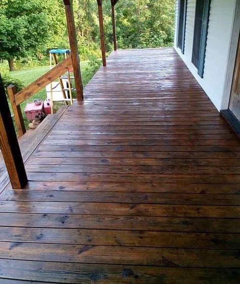 We love this stain that we used on our covered front porch, which is the length of our home. However, we are going to use the same on our side porch and back deck, which are not covered. It is absolutely beautiful! Primitive Exterior House, Dark Stain Porch, Patio Stain Colors, Porch Stain, Porch Stain Colors Wood, Dark Blue Houses, Deck Stain Colors, Green Siding, Solid Stain Colors