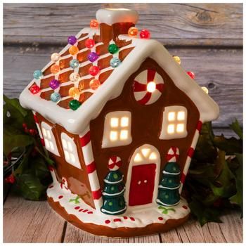 Dimensions: 10" H x 7.16" W x 7.48" D Power Source: Corded Electric Material: Ceramic & Glass Color: Brown, White, Red & Green Pattern: Stripes Care & Safety: Indoor Use Only Quantity: 1 Make your Christmas village display look brighter when you add this Light Up Gingerbread House! This charming ceramic house looks exactly like a gingerbread house, but without the frosting! Its colorful round spheres on top light up and give off a vibrant appearance. Simply turn on the lights to make your holida Up Gingerbread House, Gingerbread House Designs, Christmas Fairy Lights, Diy Christmas Village, Cookie House, Christmas Village Display, Berry Garland, Village Display, Christmas Decorations Diy Outdoor