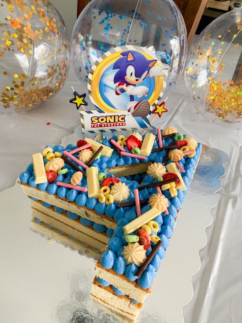 Sonic the Hedgehog Number Cake with kitkat toppings, pocky, yellow & green fruitloops, and dried strawberries 😋 Sonic Number Cake, Diy Sonic Cake, Number 5 Sonic Cake, Simple Sonic Cake, Tails Birthday Cake Sonic, Number 6 Sonic Cake, Sonic The Hedgehog Cupcakes, Golden Sonic Cake, Sonic Cookie Cake