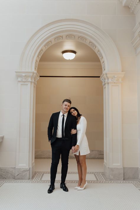 classically stylish couple share a sweet embrace surrounded by beautiful arches and artwork in the Utah State Capitol Building - Poise and Ivy Imagery White Building Photoshoot, Utah Capitol Engagements, Engagement Photos With Son, Engagement Photos Capitol, Modern Engagement Photoshoot, State Capitol Engagement Photos, Capital Building Engagement Pictures, Engagement Photo Ideas City, Utah State Capitol Photos