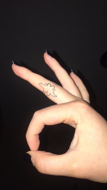 Dinosaur finger tattoo Dino Finger Tattoo, Dinosaur Finger Tattoo, Finger Tattoo Placement, Feminine Finger Tattoos, Tattoo Ideas Finger, Fingers Tattoos, Silly Tattoos, Cute Dragon Tattoo, Dino Tattoo