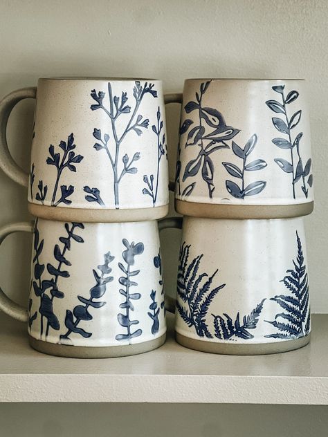 Mugs to match the ambiance of a perfect calm morning with your favorite warming sip. Each piece in the stoneware set boasts its own delicate hand-stamped botanical design. Boho Farmhouse Coffee Bar, Mug Pottery Designs, Pottery Mug Ideas Paint, Mugs Painting Ideas, Paint Your Own Pottery Ideas Mug, Hand Painted Mugs Ideas, Pottery Mug Designs, Pottery Throwing Ideas, Ceramic Mug Painting Ideas