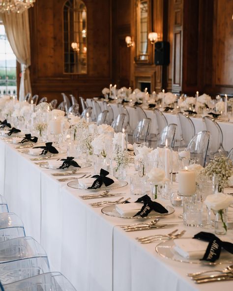 How absolutely stunning was this table set up?! With the elegance of the ballroom at @hedsor this table scape had the gorgeous low levels with the roses and modern flair with black ribbon place names and ghost chairs. Styled to perfection by @dalealexanderevents Venue @hedsor Planning & Styling @dalealexanderevents Music @quattrostringquartet Band @thelondonfunctionband Table bows @theembroiderednapkincompany Makeup @louisajaynehairmakeup Catering @cavendishevents Stationary @jellypressuk... Wedding Ghost Chairs, Black Ghost Chairs Wedding, Ribbon Place Setting, Bow Place Setting, Ghost Chair Wedding, Black Wedding Table Setting, Lao Wedding, Black Wedding Table, Hedsor House