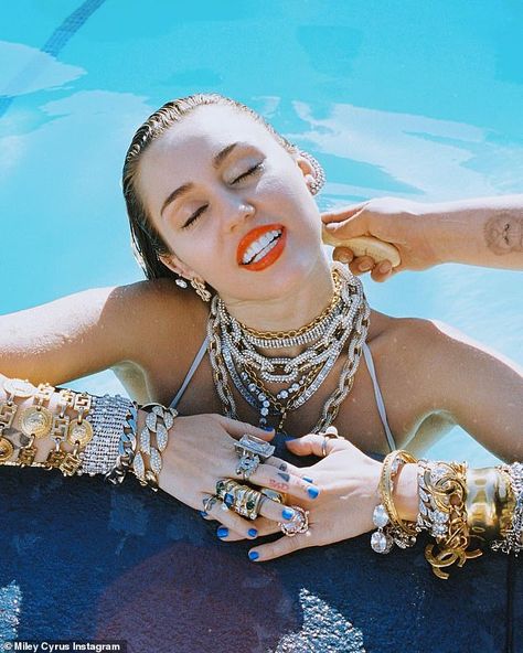 Miley Cyrus drenches herself in 'Drake's tears' and throws holy water at her haters in bikini snaps | Daily Mail Online Reflective Accessories, Miley Cyrus Photoshoot, Instagram Popular, Perfect Tan, Maddie Ziegler, Liam Hemsworth, Hannah Montana, Hailey Baldwin, Best Tv Shows