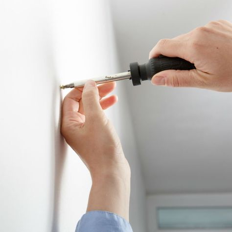 Popped Nails? Repair Your Drywall with These Tips - Bob Vila Hanging Heavy Pictures, Washing Machine Installation, Toggle Bolts, Hollow Core Doors, Drywall Anchors, Solid Brick, Bob Vila, Drywall Screws, Nail Repair