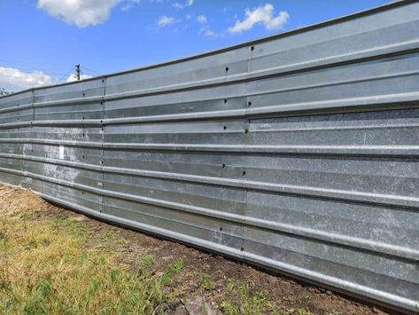 What is the Cheapest Fence to Build (With 4 Examples) How To Build A Corrugated Metal Fence, Cheap Metal Fence, Cheapest Way To Build A Fence, Affordable Fence Ideas Backyards, Cheap Privacy Fence Ideas Budget Backyard, Cost Effective Fence Ideas, Affordable Privacy Fence Ideas, Cheapest Privacy Fence Ideas, Tin Fence Ideas