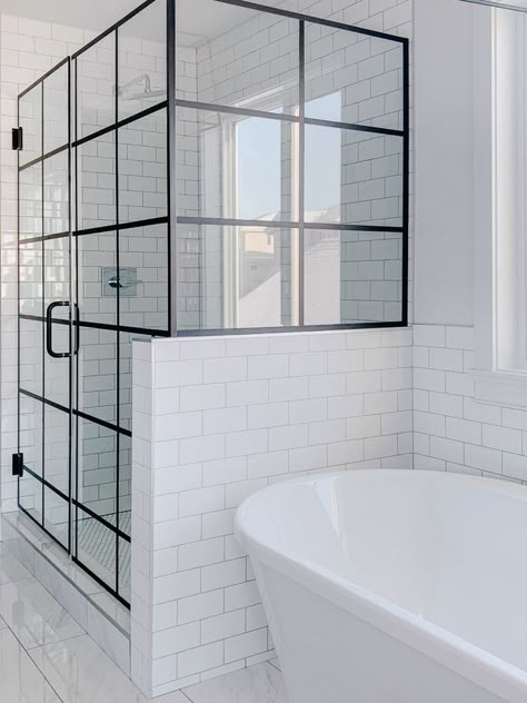 We love the way these custom black grid shower doors ground the room while the glass keeps the space feeling airy and open. A beautiful custom element in any bathroom! Iron Shower Doors, Black Iron Shower Door, Grid Shower Door Bathroom, Window Pane Shower Door, Black Grid Shower Door, Grid Shower Door, Bathroom Vision Board, Half Wall Shower, Mom Bathroom