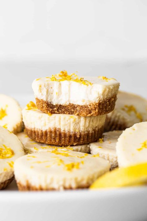 This mini cheesecake recipe is made with a sweet and salty crust, cream cheese, honey, vanilla, and lemon zest making them the perfect Spring dessert. Mini Lemon Cheesecake Bites, Mini Lemon Cheesecake, Lemon Cheesecake Bites, Lemon Cheesecakes, Baked Graham Cracker Crust, Greek Yogurt Cheesecake, Mini Lemon Cheesecakes, Trail Mix Cookies, Mini Cheesecake Bites