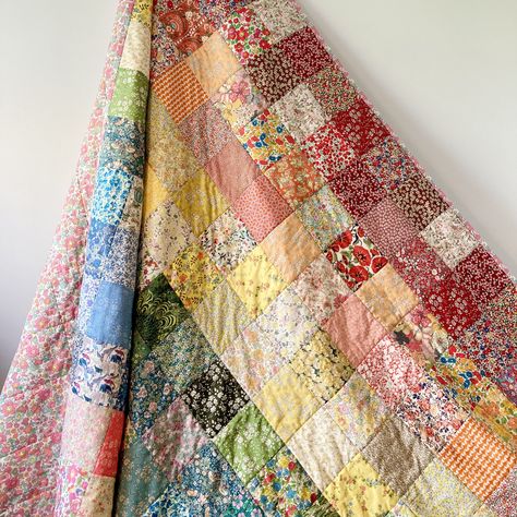 Hand sewn from Liberty Tana Lawn. Each piece has been created using patchwork squares to create a rainbow of colour in subtle, floral hues. This is an ideal child's gift or to dress a nursery. Quilts are such a tactile, comforting textile that have multiple uses for family and in the home. Each quilt is unique as I curate the fabric combinations to the rainbow with a row of reds, oranges, yellows, greens, blues, purples and pinks or violets, so there may be differences to the specific fabrics photographed. Backing Fabric: There is a standard choice of Betsy Pale Pink or Adelajda Blue but there is also a bespoke option where you can chose from a multitude of beautiful Liberty fabrics to suit your colour preferences, if this option is chosen I will be in touch to discuss ideas. One side is a Nursery Quilts, Liberty Quilt, Quilt Room, Patchwork Squares, Appliqué Ideas, Liberty Print Fabric, Liberty Fabrics, Material Things, Liberty Tana Lawn