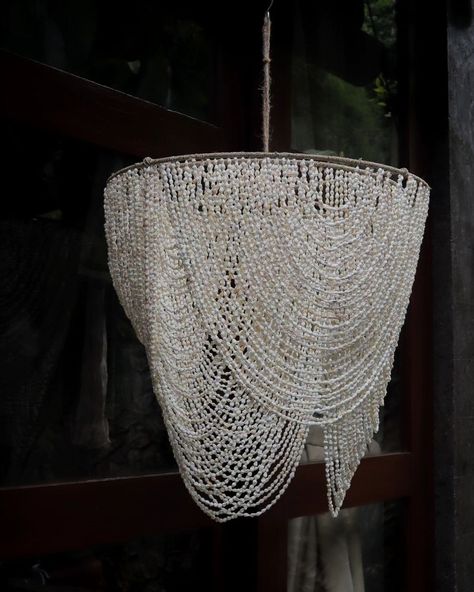 This seashell chandelier is a new design. From our experience, we combined macrame and beaded chandelier elements, making it one-of-a-kind. Handmade items are truly special. Want to create your own design? Send us a message soon 😊❤️ #SeashellChandelier #NewDesign #Macrame #BeadedChandelier #Handmade #UniqueDesign #CustomDesign Sea Shell Hanging, Seashell Chandelier, Shell Hanging, Umbrella Decorations, Shell Chandelier, Beaded Lamps, Seashell Pendants, Furniture Bedside Table, Beaded Chandelier