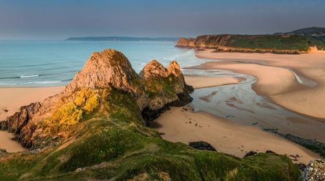 Three Cliffs Bay beach offers a wilder experience. Picture a spectacular shoreline of sand dunes, salt marsh and limestone cliffs. (Wales) Swansea Bay, Wales Holiday, Gower Peninsula, Uk Beaches, Visit Wales, Bay Photo, Wales Uk, Beaches In The World, Swansea