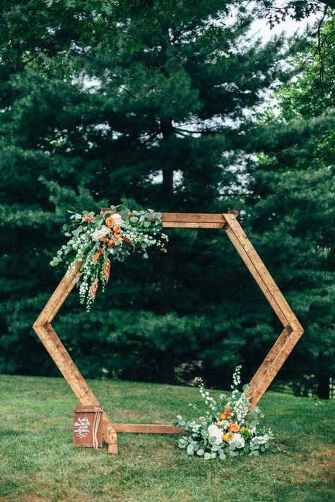 a bright hexagon wedding arch decorated with greenery, white and orange blooms for a bold summer or fall wedding Hexagon Wedding Arch, Hexagon Arch, Nature Inspired Wedding Ring, Bush Wedding, Wedding Arbors, Hexagon Wedding, Nature Inspired Wedding, Wedding Arch Flowers, Wedding Backdrop Decorations