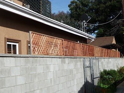 THB Construction: Privacy Trellis Added to Cinder Block Wall Cinderblock Privacy Fence, Fence Toppers For Privacy, Lattice Privacy Screen, Privacy Trellis, Cinder Block Walls, Fence Toppers, Cement Blocks, Diy Blocks, Backyard Diy