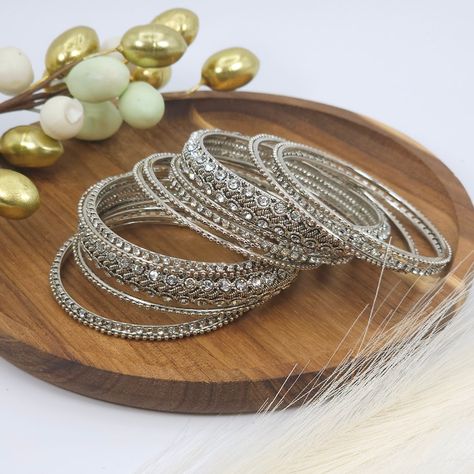 Adorn your wrists with this stunning silver polki bangle set.💫✨️ . . . . . . . . . #jewellery #goldbangles #bridaljewellery #jewellerytrends #pakistanijewellery #jewellerygifts #indianjewelleryuk #nacklaces #earrings #jewelry #bangleset #jhumkas #bangles #mathapatti #jutti #clutchbags #potlibagsforweddings #anklets #jhanjar #tikkaset #jewelleryoftheday #polkijewellery #mangtikka❤️ #jhumkabangles #goldbangles Silver Kangan, Bridal Things, Desi Jewelry, Metal Bangles, Indian Bangles, Ear Chain, Antique Silver Jewelry, Bangles Set, Gold Jewelry Stores