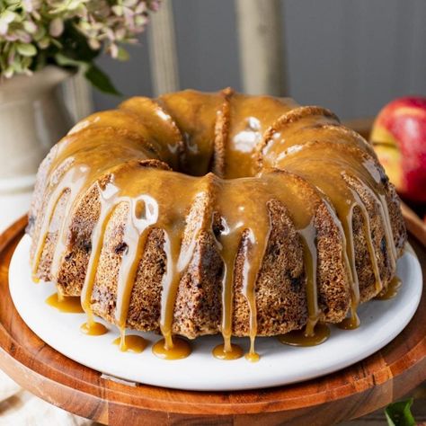 This moist apple Bundt cake is an old-fashioned, easy dessert. Also known as "Apple Dapple Cake," the warmly-spiced batter is studded with bits of fresh apples and chopped nuts, and finished with a buttery caramel sauce. Apple Pound Cake, Apple Bundt Cake Recipes, Moist Apple Cake, Apple Bundt Cake, Fresh Apple Cake, Cake With Caramel, Cake Mug, Caramel Glaze, Apple Dessert Recipes