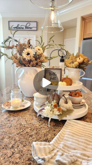 Sheila on Instagram: "Fall kitchen views! My favorite vignettes for fall include fall florals, candlelight, garden flowers and pumpkin muffins! If you watch the whole minute, you'll see I enjoy changing things up sometimes! Do you enjoy changing up your kitchen too? 

It's been a wonderful weekend, the weather is fantastic, feeling chilly at night even! I'm so happy our little garden has a few blooms to enjoy too! I hope you had a great weekend!

Fall faux florals,pear artwork, sunflower plates @HobbyLobby
White large vase, barstools @potterybarn
Pumpkin cake dome @homegoods
Fall pillow @pillowpanels

Let me know if you have questions about any other items, I'll share what I can!

#fallstyle
#fallkitchen
#falltieredtray
#tieredtraysaremyjam
#traystyling 
#fallhome
#fallhomedecor
#pumpkinse Sunflower Plates, Pear Artwork, Fall Ties, Encourage Each Other, Red Tray, Kitchen View, Sweet Kitchen, Fall Pillow, Cake Dome