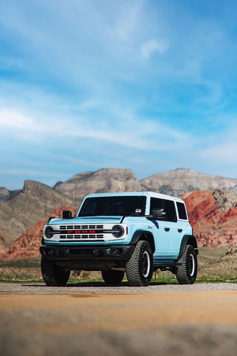 2023 Ford Bronco Heritage Edition in Robins Egg Blue Parked On A Dirt Road During The Day With Red Rock Mountains In The Background. Blue Ford Bronco Aesthetic, Bronco Light Blue, Baby Blue Bronco Ford, Blue Bronco Aesthetic, Bronco Ford 2023, Outer Banks Bronco, Bronco Wallpaper Iphone, Ford Bronco Heritage Edition, Bronco Ford Aesthetic