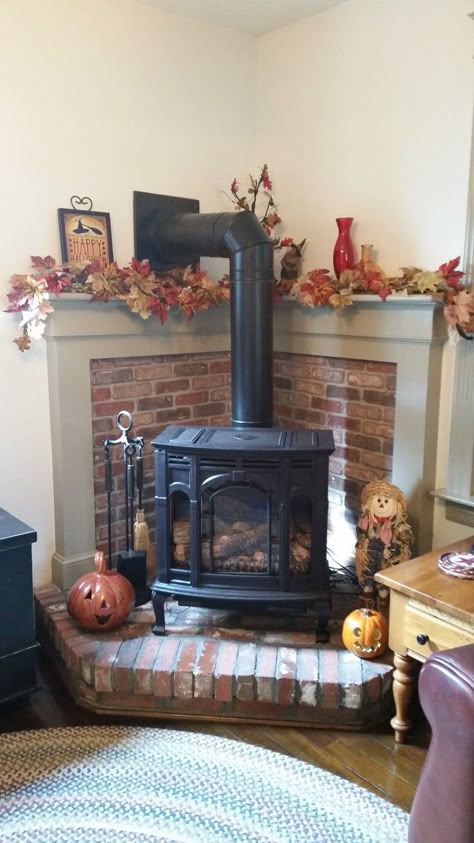 Mantel With Wood Stove, Faux Wood Stove Surround, Mantel Over Wood Stove, Wood Stove Tv Above, Corner Stove Fireplace Ideas, Wood Burning Stove Corner Ideas, Corner Wood Stove Mantle, Corner Wood Stove Mantel Ideas, Corner Wood Stove Mantel