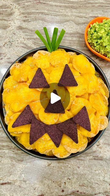 Maegan Brown ~ The BakerMama on Instagram: "JACK-O-LANTERN NACHOS 🎃🧡 So great to bake and enjoy at a Halloween party or before trick-or-treating! 

SAVE this reel for the RECIPE BELOW! ⬇️ or COMMENT “cookbook” to find it in my Spectacular Spreads cookbook, along with lots of other festive Halloween recipes 👻 #TheBakerMama #SpectacularSpreadsCookbook! 

Ingredients:
🎃 1 (13-ounce) bag round tortilla chips
🎃 2 (8-ounce) packages shredded orange cheddar cheese
🎃 9 triangle-shaped blue corn tortilla chips
🎃 4 green onions or sprigs of fresh cilantro

Instructions:
1. Preheat the oven to 400°F. Arrange half of the chips in an even layer on a round baking sheet. Sprinkle them with half of the shredded cheese. Repeat with the remaining chips and cheese. Bake for 5 to 10 minutes, until the Halloween Nachos, Chips And Cheese, Party Food Bars, Halloween Food Dinner, Food Bars, Cheese Bake, Corn Tortilla Chips, Corn Tortilla, Halloween Treats Easy