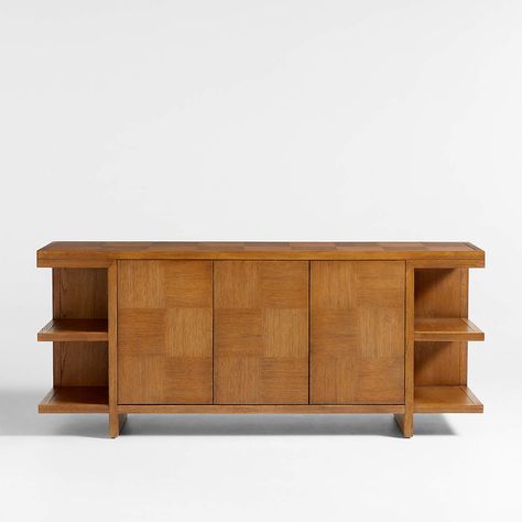 Inspired by vintage woodworking, our Pierre sideboard offers a new interpretation that's simple yet eye-catching. Check out the fascinating grid-patterned facade and top, composed of alternating squares of straight-grained oak veneer. Minimalist panels support the top, shape the legs and create two floating shelves on both sides for a modern architectural silhouette. Two cabinets—one double-door and one single-door—have flat fronts to keep the focus on the gridded design, pushing open to one adjustable shelf each.  Pierre Light Brown Oak Wood Sideboard 32.5 " H height 76 " W width 20 " D depth Measurements are in inches.   * FSC®-certified solid oak, oak veneer and engineered wood from responsibly managed forests   * Wire brushing and warm oak finish highlights wood grain   * Double- and s Crate And Barrel Aesthetic, Barrel Aesthetic, Wood Open Shelving, Credenza Wood, Bookcase Design, House Aesthetic, Mid Century Living Room, Dream Furniture, Large Sideboard