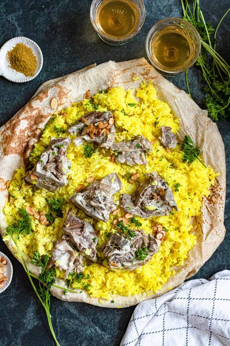 Mansaf is a traditional Jordanian meal made of lamb and rice, seasoned with a unique yogurt sauce. For an authentic taste of Jordan, this recipe is a must-try! Jordan Food Recipes, Mansaf Recipe Lamb, Jordanian Food Recipes, Mansaf Jordan, Jordanian Mansaf, Mansaf Recipe, Jordanian Recipes, Lamb And Rice, Jordanian Food