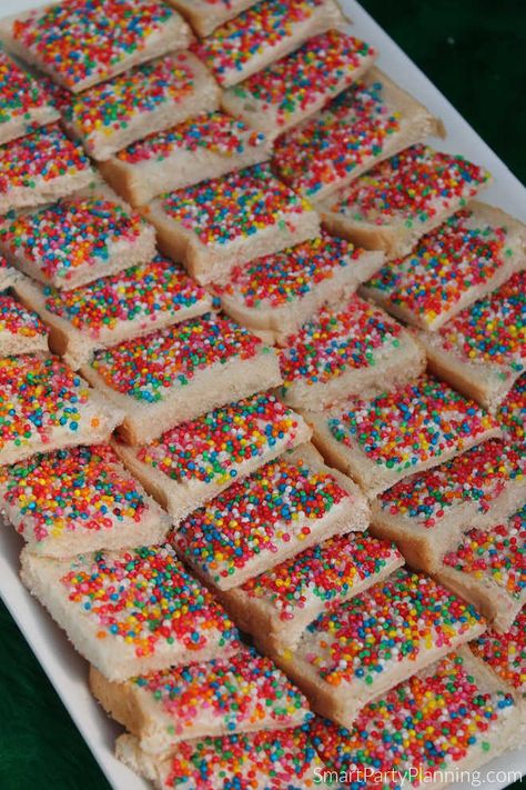 Learn how to make fairy bread for a kid’s party. Fairy bread is a party favorite for Australian kids, but will be enjoyed by kids all over the world. It is incredibly easy to organize, with a super simple recipe. Transform the fairy bread into any shape to suit all party themes. This is a total win win when it comes to catering for children’s birthday parties. Snacks For Fairy Party, Fairytale Themed Snacks, Fairy Garden Party Snacks, Fairy Dinner Party Food, Fairy Birthday Snack Ideas, Easy Kids Party Food, Fairy Snacks Kid Parties, Toddler Tea Party Birthday, Fairy Party Ideas