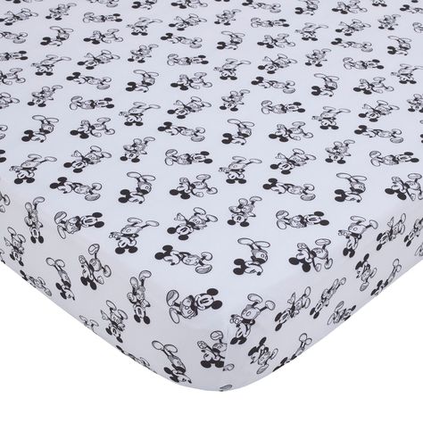 Bring a fun look to your nursery with this soft Disney Timeless Mickey Mouse Fitted Crib Sheet. This soft machine-washable sheet showcases black and white imagery of Mickey Mouse in various poses and is fully elasticized for a snug fit.    SAFETY REMINDER: Never use soft bedding, such as quilts, stuffed animals, or pillows while your baby is in any sleep environment.   Features a fun display of Mickey Mouse shown in various poses in black and white   Fits most standard crib mattresses (not included)   Fully elasticized for a snug fit   Measures 28" W x 52" L x 8" H   100% polyester   Machine wash, gentle cycle   Imported   Coordinate with other items in the Disney Timeless Mickey Mouse Nursery Bedding Collection for a complete look (sold separately) Mickey Mouse Nursery, Mickey Mouse Bedroom, Mini Crib Bedding, Mickey Mouse Design, Baby Crib Sheets, Disney Nursery, Mini Crib Sheets, Toddler Mattress, Disney Colors