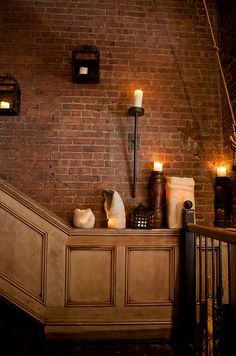 Brick accent wall with wood below Brick Wall With Wainscoting, Antique Accent Wall, Brick And Wainscotting Wall, Brick Wall Entryway, Brick Accent Wall Living Room, Half Wall Living Room, Basement Gameroom, Half Brick Wall, Staircase Bookshelf